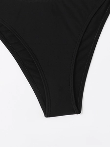 Detailed view of black bikini bottom featuring high-stretch fabric and reinforced double stitching