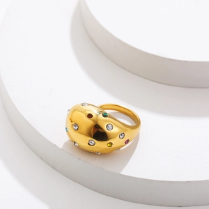 Macro detail of gold-plated stainless steel wide ring with colorful zircon stone inlay