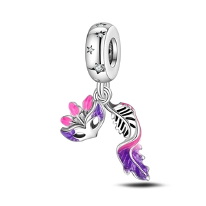 Detail of silver carnival charm with enamel feather and star-shaped zircon decoration