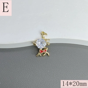 Detail view of 14x20mm gold elk pendant with white zircon inlay and red bow detail