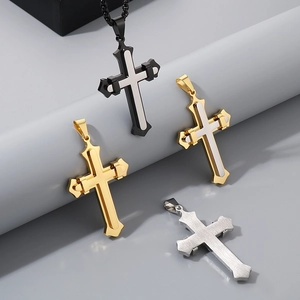 Detail view of double-layer vintage cross pendants in black, gold and silver finishes