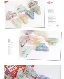 Detail of heart-shaped marble acetate hair claws in various mosaic pastel colors