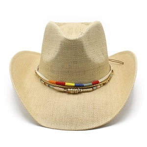Macro view of woven straw cowboy hat with bohemian multi-colored ethnic decorative band