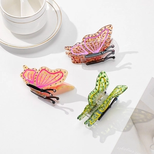 Three acetate butterfly hair claws with rhinestones in pink, orange and green leopard prints