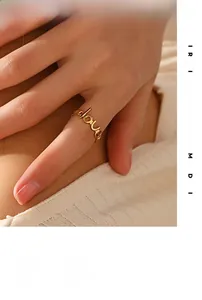 Detail of 18K gold-plated LOVE letter ring with high-polish finish on female finger