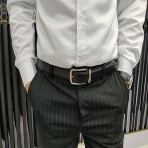 Men's premium black leather belt with a classic silver alloy pin buckle on casual attire