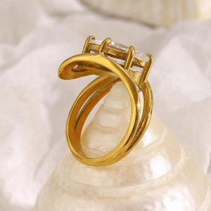 Detail of 18K gold plated double layer ring with zircon displayed on a white seashell