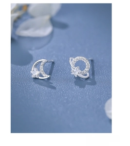 Detail of S925 sterling silver moon and star stud earrings with sparkly cubic zirconia