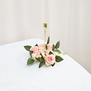 Detail of pink silk roses and hydrangea wreath base on a gold metal candle holder stand