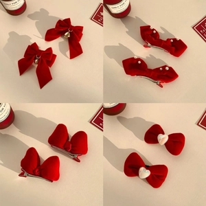 Set of red velvet bow hair clips with pearls and gold bells for festive styling