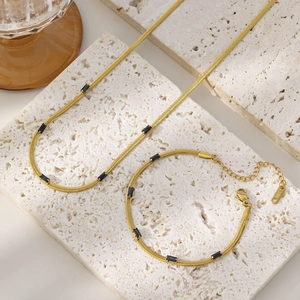 Detailed set of gold plated steel snake chain with rectangular black zircon stone