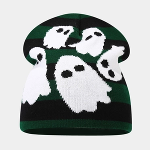 Detail of green and black striped knit beanie featuring white ghost patterns for Halloween