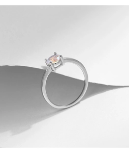 Macro shot of silver S925 ring featuring an oval colorful zircon in a four-prong setting