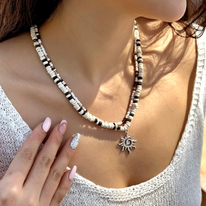 Double-layered beaded necklace with sun pendant, featuring coconut shells and wood beads