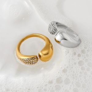 Polished gold and silver adjustable rings with teardrop design and pavé crystal accents