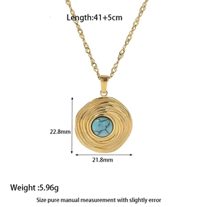 Detail view of a vintage gold pendant necklace featuring a centered turquoise stone inlay