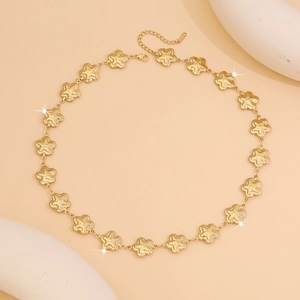 Macro shot of gold stainless steel star chain necklace with lobster clasp and extension