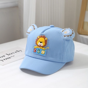Detail of baby lion baseball cap with cute ears and zoo embroidery in light blue cotton