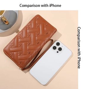 Brown quilted leather long wallet with heart pattern compared to an iPhone for size