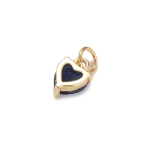 Detailed view of heart-shaped gold-plated pendant with deep blue zircon gemstone inlay