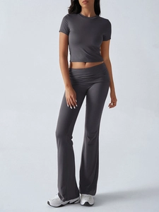 Detailed view of women's dark grey short sleeve crop top and high-waisted flared pants