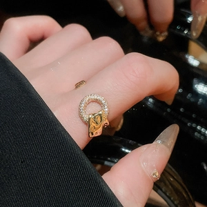 Macro shot of gold zircon geometric ring showing detailed pavé stones on finger