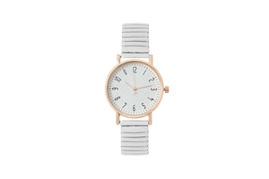 Detail view of white textured dial with rose gold case and stretch metal watch band