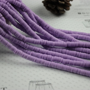 Detailed view of purple polymer clay heishi beads for DIY jewelry making and bracelets