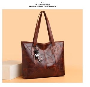 Brown faux leather tote bag with unique texture and cute bear pendant detail