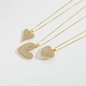 Luxurious gold heart pendant necklace set with sparkling white zircon pave on white base