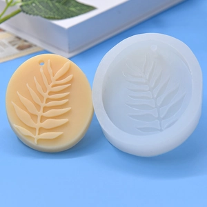 Detailed view of leaf pattern silicone mold with textured resin craft on blue background