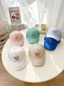 Detail of mesh baseball caps with My little cutie embroidery in six vibrant colors