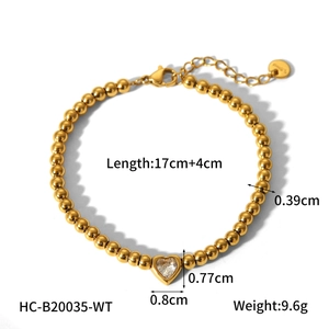 Detail of 18K gold stainless steel beaded bracelet with crystal heart pendant and sizing info