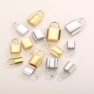 Detailed view of various gold and silver stainless steel lock pendants in multiple sizes