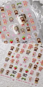 Detail showing Lolita-style bear nail stickers with embossed hearts and strawberries