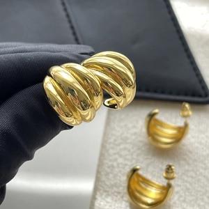 Three-tier C-shaped gold-plated metal hoop earrings with a textured ribbed cocoon design
