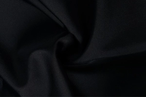 Close-up of premium black ribbed fabric showing detailed high-density weave texture