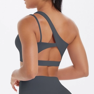 Detailed back view of dark grey sports bra with asymmetric straps and cutout design