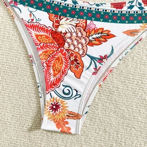 Close-up of floral and geometric ethnic print on women's white bikini bottoms