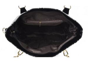 Interior view of black leather tote bag featuring a zipper pocket and two open slots
