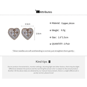 Close-up of zircon heart cross earrings with dimensions and specifications detail