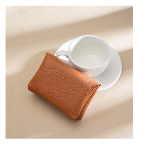 Detailed macro view of pebble grain brown genuine leather coin purse and card holder