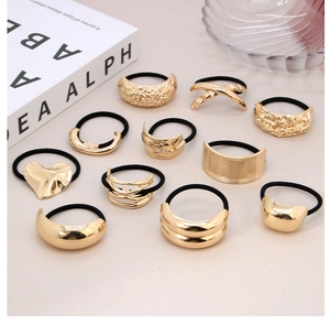 Flat lay of vintage irregular gold alloy hair ties set with minimalist metallic textures
