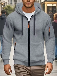 Close-up of heather gray zip-up hoodie with detailed knit texture and orange zipper tabs