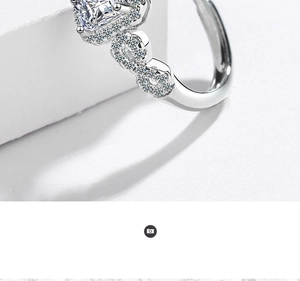 Macro shot of silver ring with heart-shaped stone and infinity design on the band