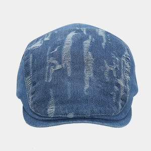 Vintage blue denim ivy cap with distressed ripped details and flat brim style