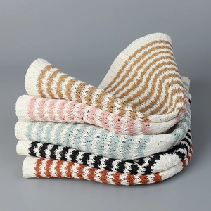 Close-up of colorful crochet knit bucket hats with bohemian wavy stripe patterns
