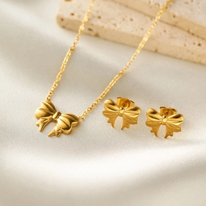 Elegant 18K gold stainless steel jewelry set with ribbon bow necklace and earrings