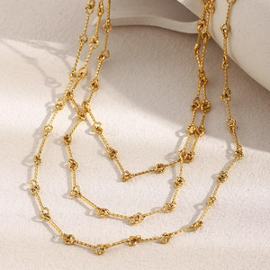 Detailed view of layered 18K gold-plated necklace with textured chain link design
