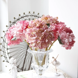 Detailed view of pink vintage artificial hydrangea in a glass vase for home decor